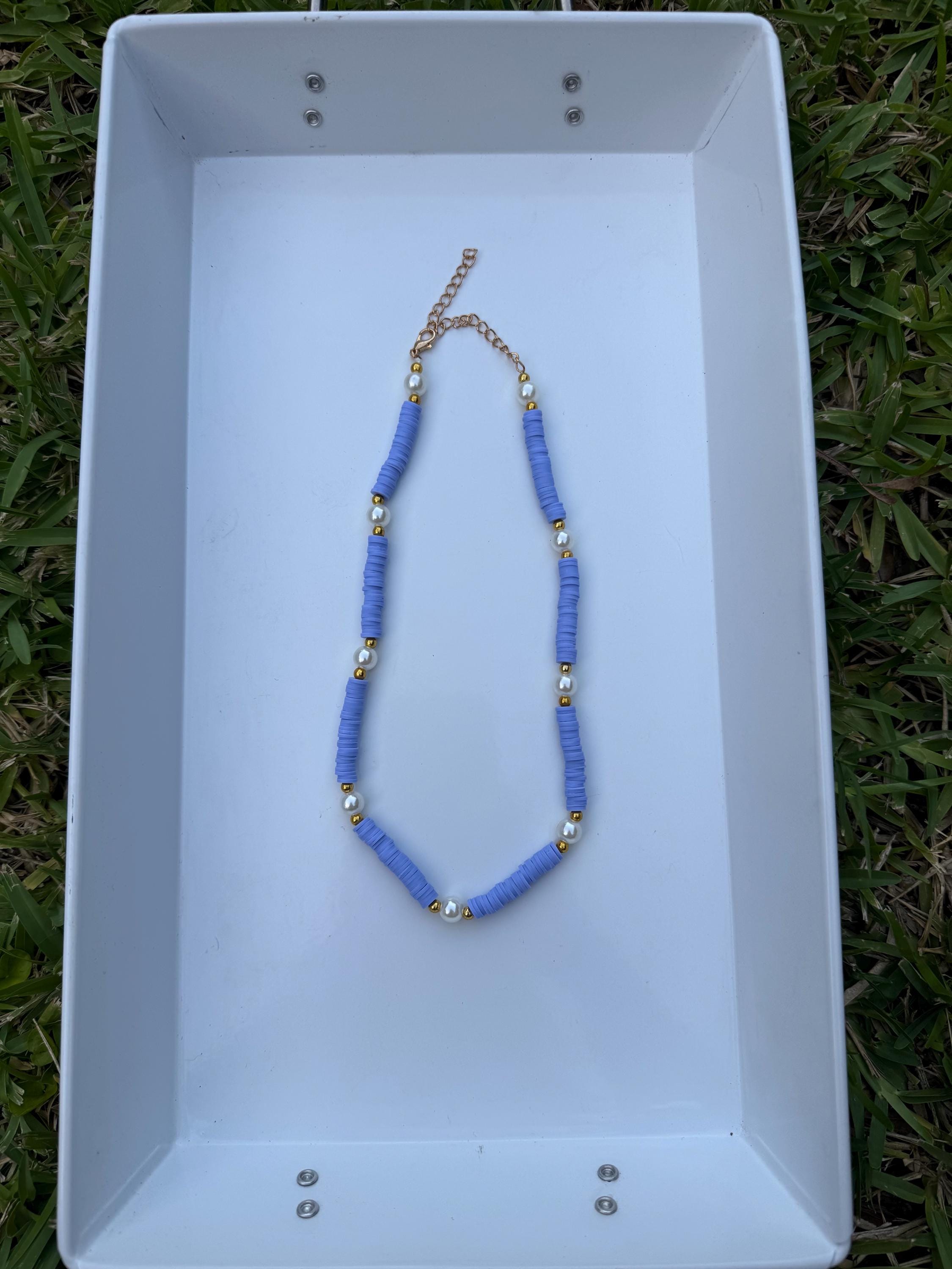 purple and big pearl necklace