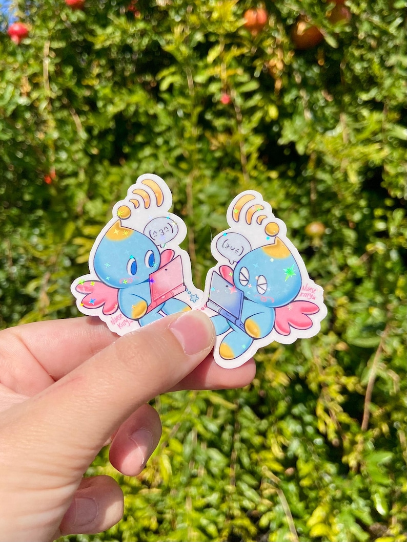 May include: Two stickers featuring a blue cartoon creature with wings, holding a pink laptop. The creature has a yellow antenna and a star-shaped sparkle. Text bubbles above the creature read "(232)" and "(2us)". The stickers are held against a green, leafy background.