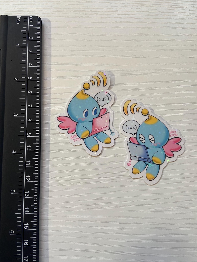 May include: Two stickers featuring a blue cartoon creature with a yellow head, pink wings, and holding a pink laptop. The stickers have a white border and the text "Nurse Kitty". The stickers are approximately 2 inches in height.