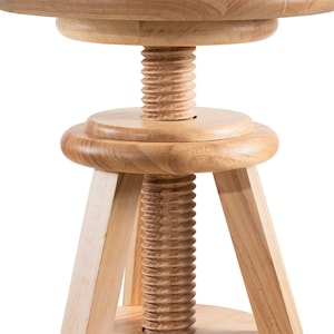 May include: A light-coloured wooden adjustable stool with a round seat and a threaded central column. The stool has three angled legs and a circular base. The seat and base are approximately 30 cm in diameter.