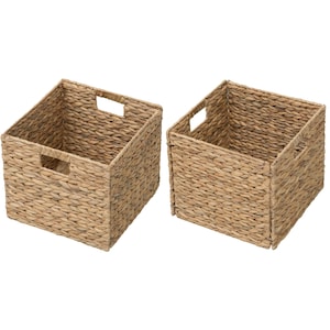 May include: Two woven storage baskets. Each basket is square with a rectangular handle cut out on each side. The baskets are made of a light brown, natural material. The baskets are empty and ready to be filled.