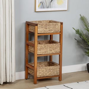 May include: A three-tiered storage unit with woven baskets and a wooden frame. The baskets are a light tan color, and the frame is a medium brown. The unit is designed for organizing and storage.
