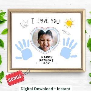 May include: A printable Father's Day card featuring a blue handprint, a heart with a child's photo, and the text "I love you" and "Happy Father's Day".