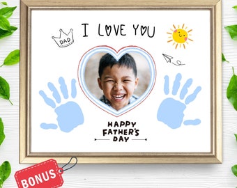 May include: A printable Father's Day card with a blue handprint, a heart with a photo of a child, and the text "I love you" and "Happy Father's Day".