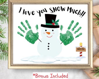 May include: A printable Christmas card featuring a snowman with green handprints, a black top hat, and a sign that says "North Pole". The card reads "I love you snow much!!"