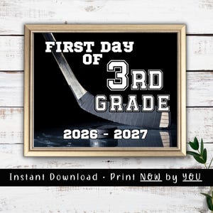 May include: A framed sign featuring a black background with a hockey stick and puck. The white text reads FIRST DAY OF 3RD GRADE and 2026-2027. The design is presented in a light-colored wooden frame against a white rustic wood plank background.