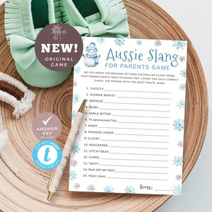 May include: A printable game card with a blue and white snowflake design. The card has the title "Aussie Slang for Parents Game" and lists 15 Australian slang terms with blank spaces for players to write in the meaning of each term. The card also includes a snowman illustration and a space for a score.
