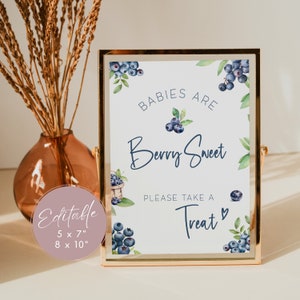 May include: A printable sign with blueberries and greenery, reading "Babies are Berry Sweet. Please take a Treat."  The sign is in a gold frame and is available in 5x7 inches or 8x10 inches.