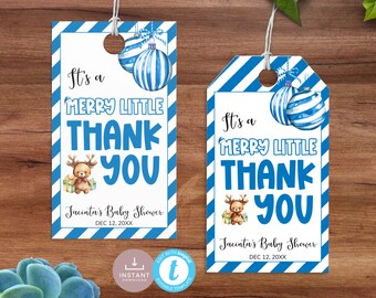 May include: Two baby shower thank you tags with blue and white diagonal stripes. The tags read "It's a Merry Little Thank You" with a reindeer and ornaments. The text "Jacinta's Baby Shower" and the date are also included.