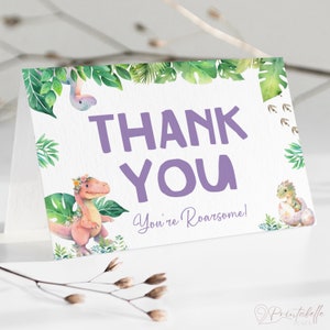 May include: Thank you card with a purple dinosaur and green leaves. The text says "Thank You You're Roarsome!"