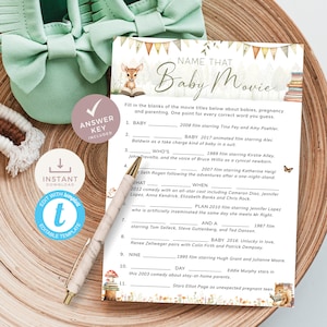 May include: A printable baby shower game with a woodland theme. The game is called "Name That Baby Movie" and asks players to fill in the blanks of movie titles related to babies, pregnancy, and parenting. The game features a cute deer illustration and a whimsical font.