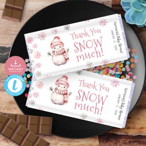 May include: Two white chocolate bar wrappers with a pink and white snowman illustration and the text "Thank You SNOW much!" and "Veronica's Baby Shower January 12, 20XX".