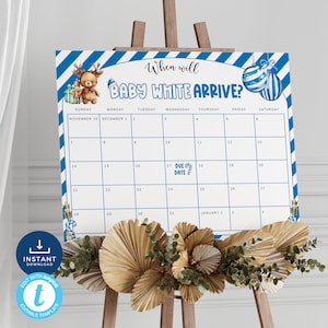 May include: A blue and white striped printable calendar with a cute cartoon reindeer and the text "When will Baby White Arrive?"  The calendar is for the months of November and December and includes a due date marker.
