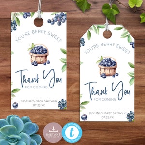 May include: Two white gift tags with a blueberry theme. Each tag features a watercolor illustration of a basket filled with blueberries, surrounded by green leaves. Text reads "You're Berry Sweet" and "Thank You for Coming."