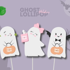 May include: Three white ghost-shaped lollipop holders on sticks. The left ghost has green bolts, the middle has a pink bow and bag, and the right has black bat wings and a bowtie. Each holds an orange pumpkin bucket labeled Trick or Treat.