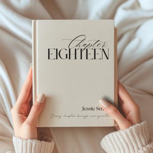 May include: A cream-colored book with black text on the front cover. The cover features the words Chapter EIGHTEEN in a mix of script and serif fonts, followed by the name Jessie Sm and the phrase Every chapter brings new growth.