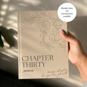 May include: A beige hardcover book featuring a black line art floral illustration on the cover. The text reads CHAPTER THIRTY, JESSCIA, and Every chapter brings new growth. A circular white graphic overlay states Multiple colors and customisations available!