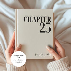 May include: A cream-colored hardcover book featuring the black text "CHAPTER 25" prominently displayed on the front cover, with the name "Jessica Smith" printed in a smaller font at the bottom. The book has a smooth, matte finish and clean edges.