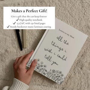 May include: A white notebook with the text "Letters to my Mom" and "all the things I wish I could tell you" in black script. The notebook has a floral border and measures 5.75"x8" with 150 lined pages. A black pen and a beige lipstick are also visible.