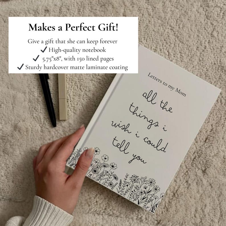 May include: A white notebook with the text "Letters to my Mom" and "all the things I wish I could tell you" in black script. The notebook has a floral border and measures 5.75"x8" with 150 lined pages. A black pen and a beige lipstick are also visible.