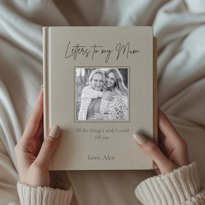 May include: A beige book titled "Letters to my Mum" with a black and white photo of two people hugging. The text "All the things I wish I could tell you" and "Love, Alex" are also on the cover.