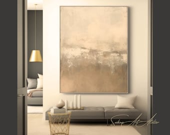 May include: Abstract painting in shades of beige, brown, and white with a textured finish. The painting is framed and hanging on a wall in a modern interior.