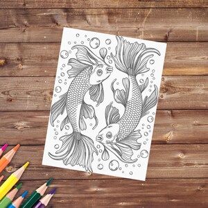May include: A black and white line drawing of two goldfish swimming in a circle. The fish have detailed scales and fins. There are bubbles around the fish.