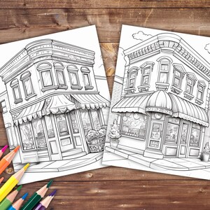 May include: Two black and white line drawings of storefront buildings with awnings. The buildings have three windows each and are drawn in a detailed style.