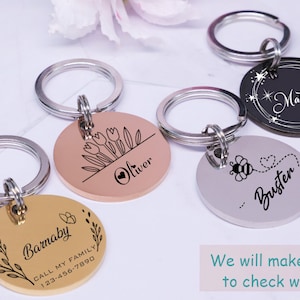 May include: Four personalized keychains with different designs. The keychains are silver, gold, rose gold, and black. The designs include a bee, flowers, stars, and a heart. The keychains are engraved with the names Barnaby, Oliver, Buster, and Mabel.