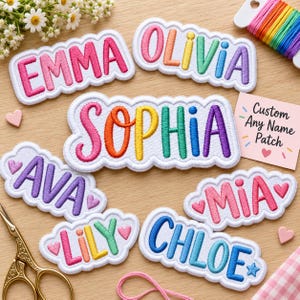 May include: A collection of embroidered name patches featuring the names EMMA, OLIVIA, SOPHIA, AVA, MIA, LILY, and CHLOE in colourful, puffy lettering with white scalloped borders. A small card reads Custom Any Name Patch with a heart icon.