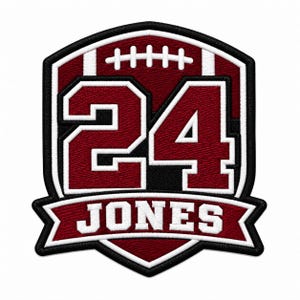 May include: A shield-shaped embroidered patch featuring a maroon football graphic with white laces, the number 24 in large maroon digits with white outlines, and a maroon banner at the bottom displaying the name JONES in white block letters.