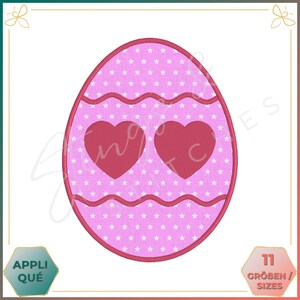May include: Pink Easter egg with two red hearts and a white star pattern.