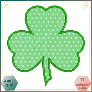 May include: Green shamrock applique with a white star pattern. The shamrock has a green outline.