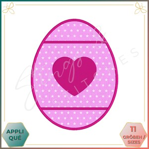 May include: Pink Easter egg embroidery design with a white star pattern and a pink heart in the center. The design has two pink lines across the egg.