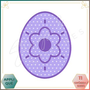 May include: Purple Easter egg embroidery design with a white star pattern and a purple flower in the centre.