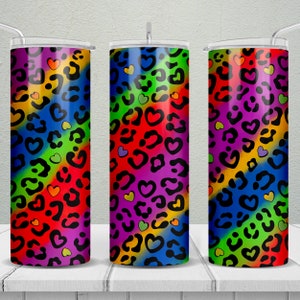 May include: Three stainless steel tumblers with a rainbow leopard print and small hearts. The tumblers are all the same size and have a clear lid.