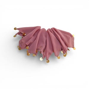 May include: A dusky pink scarf with a scalloped edge, decorated with gold sequins and small white beads. The scarf is arranged in a semi-circular shape, with the sequins and beads adding a touch of sparkle.