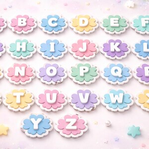 May include: A collection of colorful alphabet letters, each in a different pastel color, arranged in a grid. Each letter is white and set on a flower-shaped base. The background is a soft, blurred pastel with star-shaped decorations.