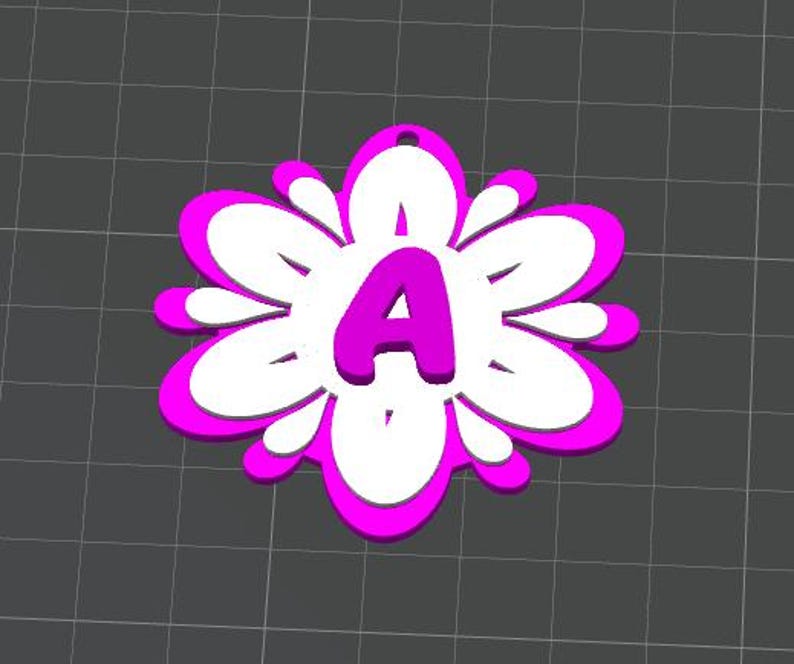 May include: A flower-shaped pendant with a bright pink outline and a white interior. The letter "A" is prominently displayed in the center, also in pink. The pendant has a small hole at the top for hanging.