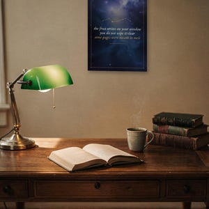 May include: A rectangular wall art print featuring a dark blue nebula background with a gold constellation and the text: the frost writes on your window, you do not wipe it clear, some pages were meant to melt, enclosed in a thin gold border.