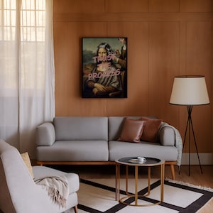 May include: A modern living room with a grey sofa, brown cushions, and a round coffee table. A framed artwork of the Mona Lisa with the text "Trust the Process" is displayed. The room features wooden panelling, a floor lamp, and a patterned rug.