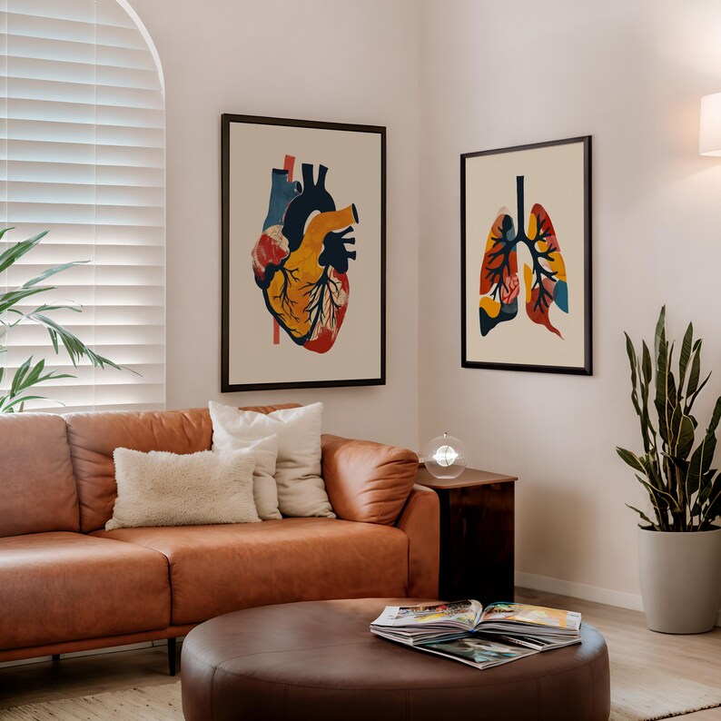 May include: Two framed art prints depicting anatomical illustrations of the heart and lungs. The heart print features a colorful depiction with shades of blue, yellow, and red. The lung print showcases a similar style with vibrant hues of orange, blue, and yellow.