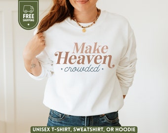 May include: White sweatshirt with the text "Make Heaven crowded" in brown and blue lettering.