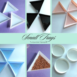 May include: Set of small triangle trays in various colours, including white, black, pink, blue, and turquoise. The trays are made of plastic and are ideal for organising small items.  Small Trays Turquoise Opaque.