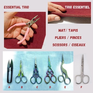 May include: A set of six sewing tools, including a pair of pink pliers, a pair of black fabric shears, and four pairs of decorative scissors with rainbow-colored finishes. The tools are arranged on a blue surface. The text "ESSENTIAL TRIO" and "TRIO ESSENTIEL" is visible in the image.