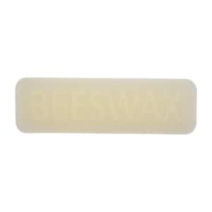 May include: A rectangular bar of beeswax with rounded edges. The word "BEESWAX" is embossed across the center of the bar in capital letters. The bar has a pale yellow color.