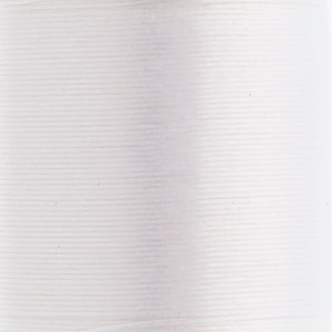 Peut inclure: Une bobine de fil à coudre blanc présentant une structure cylindrique étroitement enroulée. La surface affiche une texture horizontale fine et cohérente créée par les brins individuels de fil enroulés autour du noyau central de la bobine.
