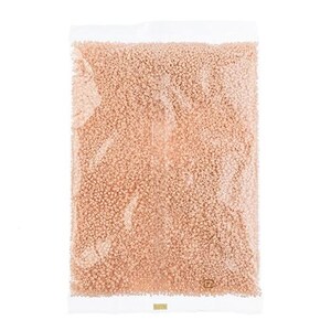 May include: A clear plastic bag filled with small, light peach-colored beads.