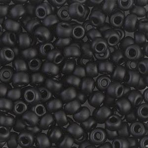 May include: A collection of matte black beads. Each bead is cylindrical with a rounded form and a central hole. The beads are scattered, creating a textured appearance. These beads are suitable for jewellery making and crafts. The beads are approximately 0.6 cm in diameter.