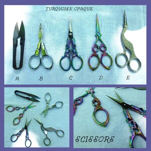 May include: A collection of ten decorative scissors with iridescent rainbow finishes. The scissors are arranged in two rows, with the top row labeled "TURQUOISE OPAQUE" and the bottom row labeled "SCISSORS".